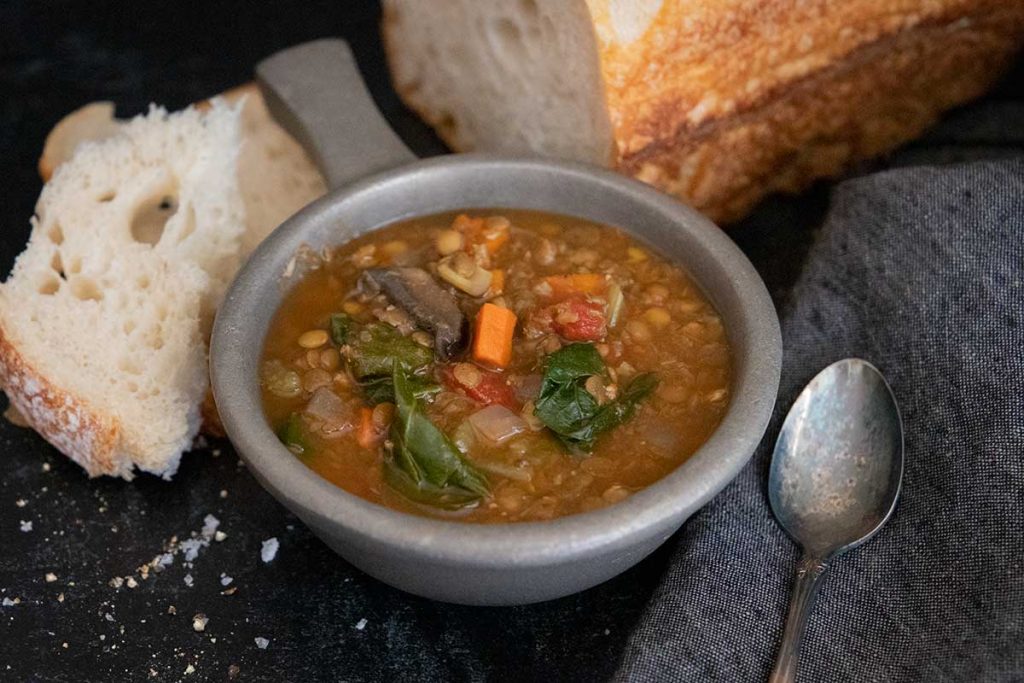 Lentil spinach soups with a loaf of bread